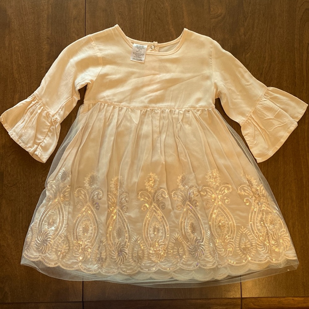 3t cream colored dress with a fun gold and brown design on the bottom